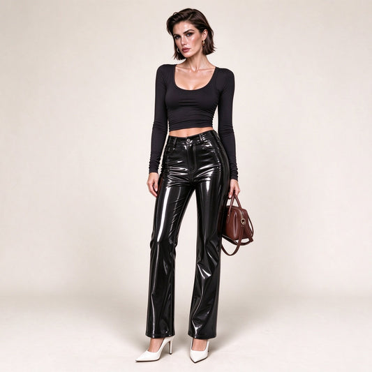 Model wearing black patent faux leather high-waisted straight-leg pants with flare hem