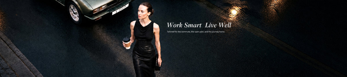 Work Smart. Live Well - woman in a black cowl-neck top and glossy black PU leather maxi skirt walking on a wet city street at night